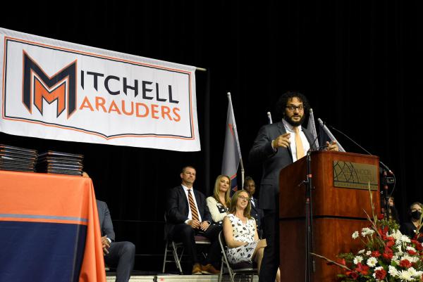 Kareem Sayegh, Student Success Manager at NCS, speaks at the 2023 graduation of Mitchell High School, Colorado Springs School District 11.
