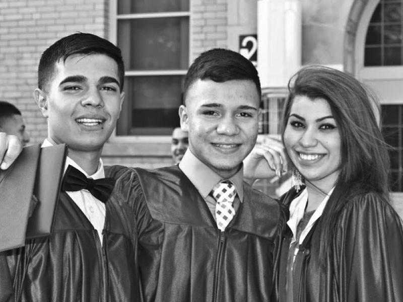 Three young graduates in gowns