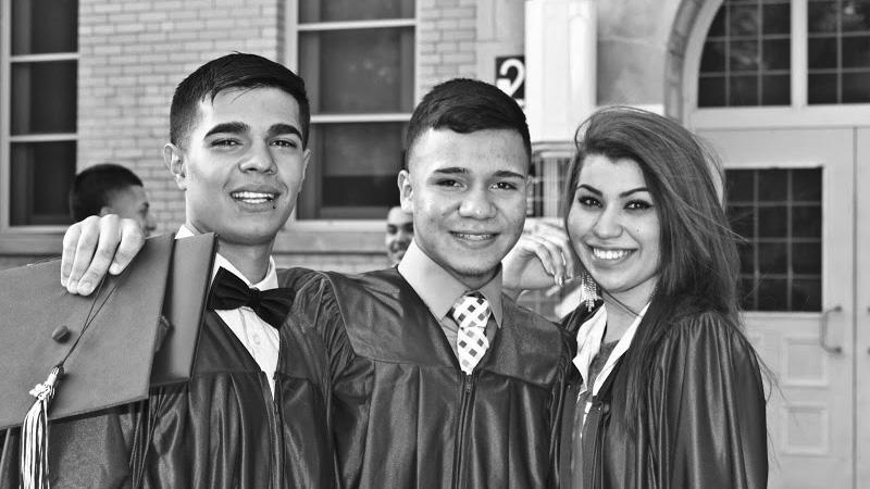 Three young graduates in gowns